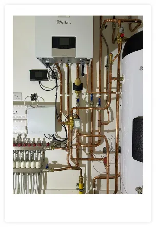 A photo showing the copper pipework beneath a boiler