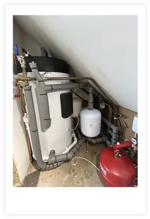 A boiler showing the insulation around the pipework