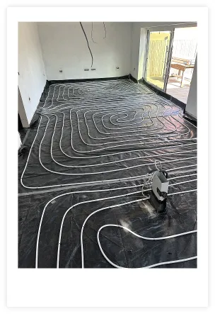 Photo showing Underfloor heating pipes being installed