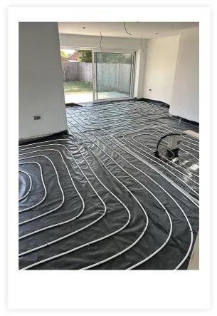 Photo showing Underfloor heating pipes being installed