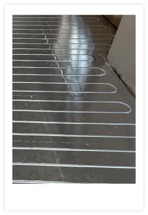 Photo showing Underfloor heating pipes being installed